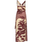 The Nouvel Arome Maxi Dress by Johanna Ortiz features a sleeveless, V-neck design with thin straps and a cream base adorned with maroon palm tree prints.