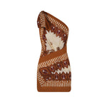 The Sun Traveller Mini Dress by Johanna Ortiz is a brown and beige one-shoulder mini dress with leaf and geometric prints, a knotted shoulder detail, and a fitted silhouette.