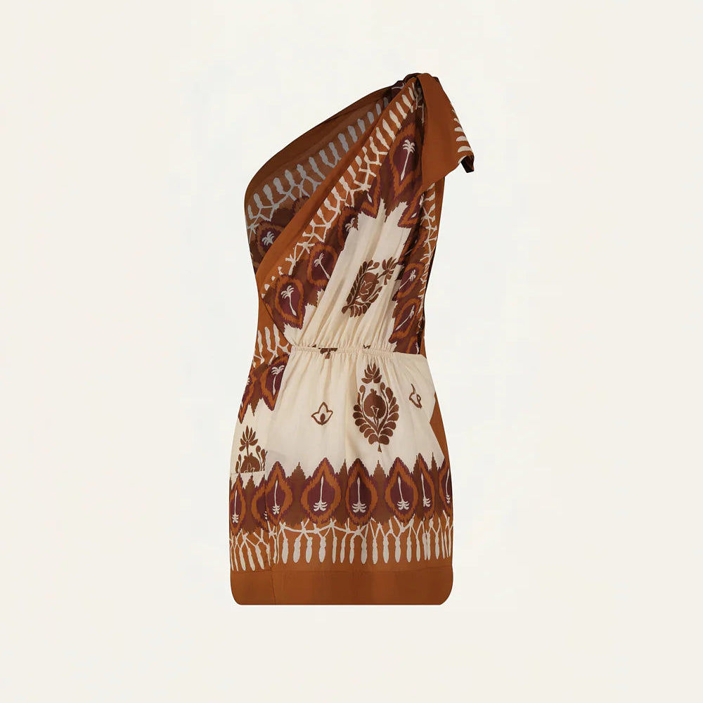 The Sun Traveller Mini Dress by Johanna Ortiz features a one-shoulder, asymmetric neckline, gathered waist, and brown and cream floral and geometric patterns.