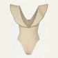 The Crinkle Beaches One Piece by Johanna Ortiz is a beige swimsuit made from crinkle lycra, showcasing a deep V-neck and wide ruffled shoulders for a chic beach look.