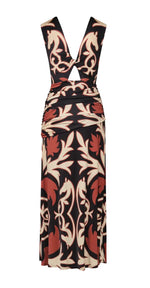 The Horizonte Mistico Midi Dress by Johanna Ortiz is a sleeveless, midi-length style with a front cutout and ruched waist, showcasing a striking brown, black, and cream abstract floral pattern inspired by the Equine Mola Tiles motif.