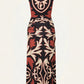The Horizonte Mistico Midi Dress by Johanna Ortiz is a sleeveless, midi-length piece adorned with a bold abstract pattern in brown, black, and cream. Featuring side ruching around the waist and hips and finished with a straight hem, this dress—shown from the back against a light background—takes inspiration from the Equine Mola Tiles motif for a distinctive look.