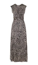 The Silent Rising Dress by Johanna Ortiz is a sleeveless, ankle-length piece showcasing a striking black and white External Feathers motif. It features a gathered twist detail at the waist and a gently flared hem, crafted from soft double-sided jersey for exceptional comfort and fluid drape.