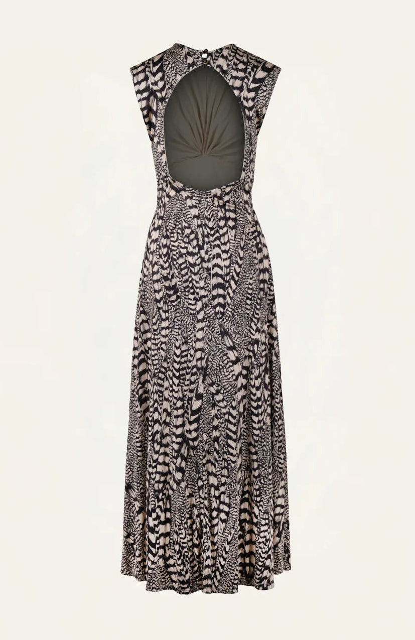 The Silent Rising Dress by Johanna Ortiz is a sleeveless, ankle-length piece crafted from soft double-sided jersey and adorned with a striking black and white External Feathers motif. This elegant dress features a large circular back cutout and a flowy skirt that adds graceful movement.
