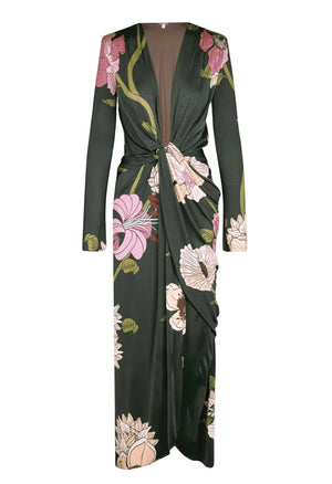 Johanna Ortiz Reinvention Oasis Ankle Dress: a dark green, ankle-length, long-sleeved shiny jersey dress with a pink and white botanical motif, deep V-neck, and knotted front detail.