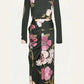 Back view of the black Johanna Ortiz Reinvention Oasis Ankle Dress with a pink botanical motif, long sleeves, ankle-length hem, and gathered side detailing.