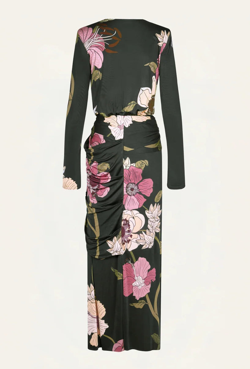 Back view of the black Johanna Ortiz Reinvention Oasis Ankle Dress with a pink botanical motif, long sleeves, ankle-length hem, and gathered side detailing.