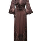 Back view of the brown, long-sleeved Timeless Concurse Wrap Dress featuring a pink and black botanical motif.