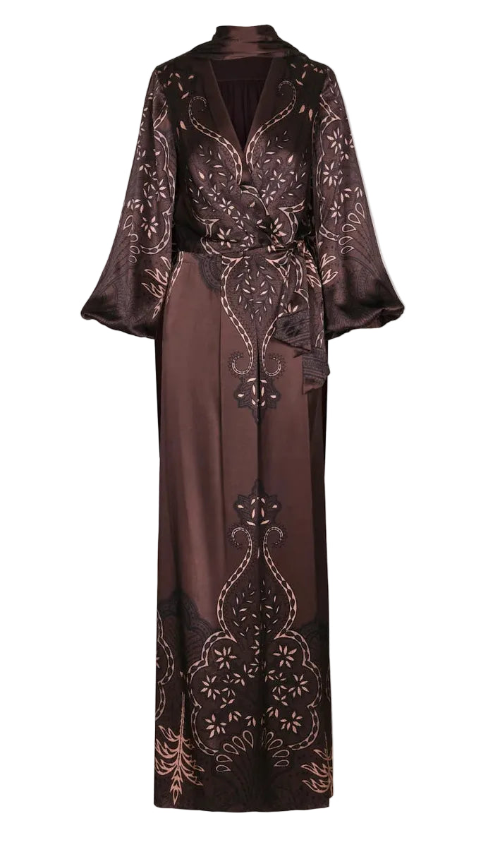 Johanna Ortiz Timeless Concurse Wrap Dress in dark brown silk with a V-neck, long billowy sleeves, and an ornate cream and black botanical motif along the hem and bodice.