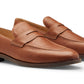 The Peter Millar Madison Penny Loafers are brown tumbled calf leather shoes with low heels and stitched detailing, shown side by side on a white background.