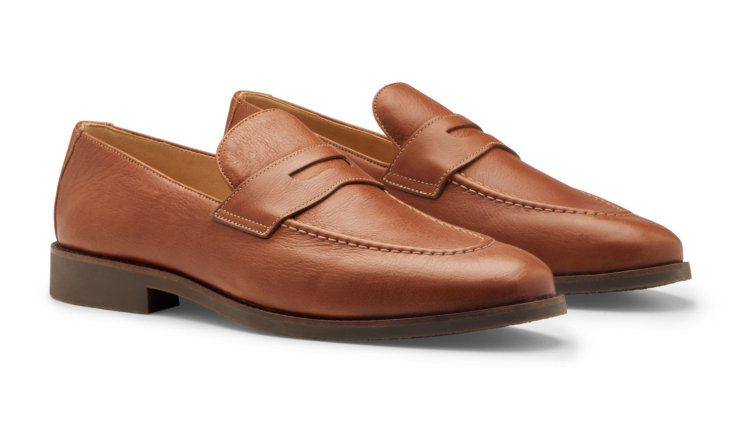 The Peter Millar Madison Penny Loafers are brown tumbled calf leather shoes with low heels and stitched detailing, shown side by side on a white background.