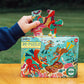 A person is holding a vibrant puzzle piece from the box marked "eeboo Deep Sea Treasure 20 Piece Puzzle" by Eeboo, showcasing an engaging underwater treasure hunt scene filled with vivid sea creatures and plants. The jumbo-sized pieces are designed for easy handling and assembly, making it suitable for puzzlers of all ages.