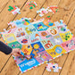 A hand places a piece in the Eeboo Alphabet 36 Piece Giant Puzzle, illustrated by Sarah Walsh and showing animals and objects for each letter, on a wooden floor.