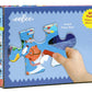 A hand holds a large puzzle piece in front of the Eeboo Sea Exploration 20 Piece Big Puzzle box, featuring vibrant artwork and showcasing its big 11"x15" size.