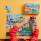 A child wearing a red shirt is assembling the vibrant eeboo Vehicles 20 Piece Puzzle by Eeboo on a yellow table. The puzzle box is on the table, indicating it is a 20-piece set, which features a bustling city of vehicles and is excellent for enhancing hand-eye coordination.