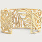 The Anabel Aram Palm Leaves Cuff features 18k gold-dipped openwork palm fronds with hand-set crystals, showcased on a neutral background.