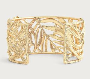 The Anabel Aram Palm Leaves Cuff features 18k gold-dipped openwork palm fronds with hand-set crystals, showcased on a neutral background.