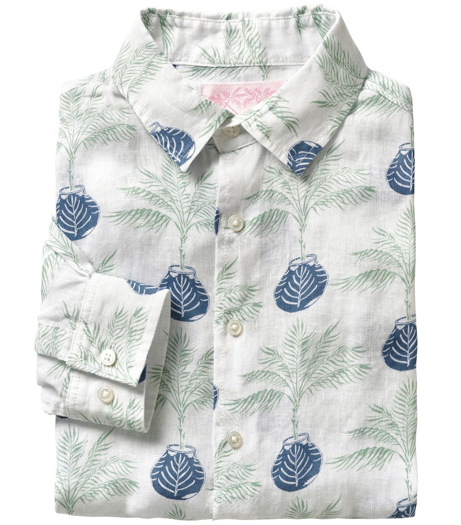 Folded Pink House Mustique's men's button-down linen shirt showcasing a green and blue leaf and palm print on a light background. This OEKO-TEX certified Pink House Mustique Printed Linen Shirt guarantees eco-friendly comfort with its breathable, pre-washed fabric.