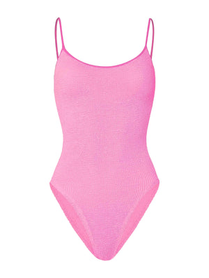The Pamela Swim by Hunza G is a light pink one-piece swimsuit in Original Crinkle fabric, featuring thin spaghetti straps and a scoop neckline for adjustable coverage. Shown on a plain white background.