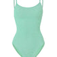 Pamela Swim by Hunza G in light green is a one-piece swimsuit crafted from the brand’s signature Original Crinkle™ fabrication, featuring thin shoulder straps, a scoop neckline, and textured fabric for adjustable coverage, shown against a white background.