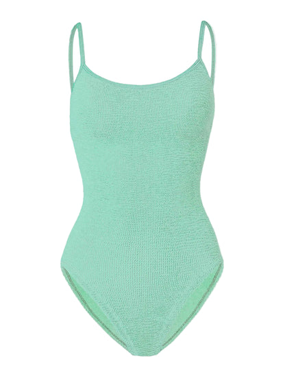 Pamela Swim by Hunza G in light green is a one-piece swimsuit crafted from the brand’s signature Original Crinkle™ fabrication, featuring thin shoulder straps, a scoop neckline, and textured fabric for adjustable coverage, shown against a white background.