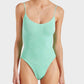 A person is wearing the Hunza G Pamela Swim, a light green one-piece swimsuit made from our signature Original Crinkle™ fabrication with thin straps, standing against a plain background.