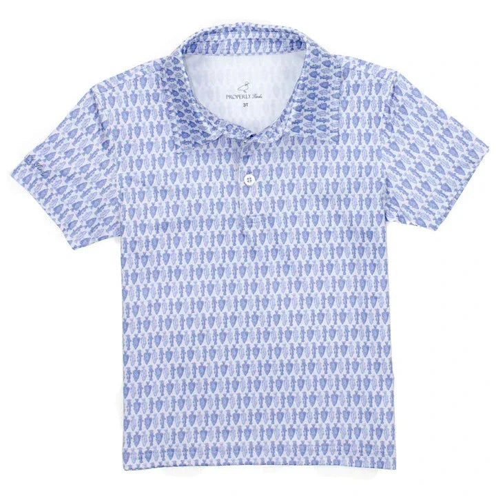 The Properly Tied Boys' Inlet Polo is a short-sleeved collared shirt adorned with a delightful blue and white penguin pattern, ideal for everyday wear.