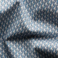 Close-up of Eton's Cut Away Slim Signature Twill Parrot Shirt, showcasing a repeating pattern of interlocking blue and gray shapes on white. Crafted from extra-long staple cotton for a wrinkle-free finish.