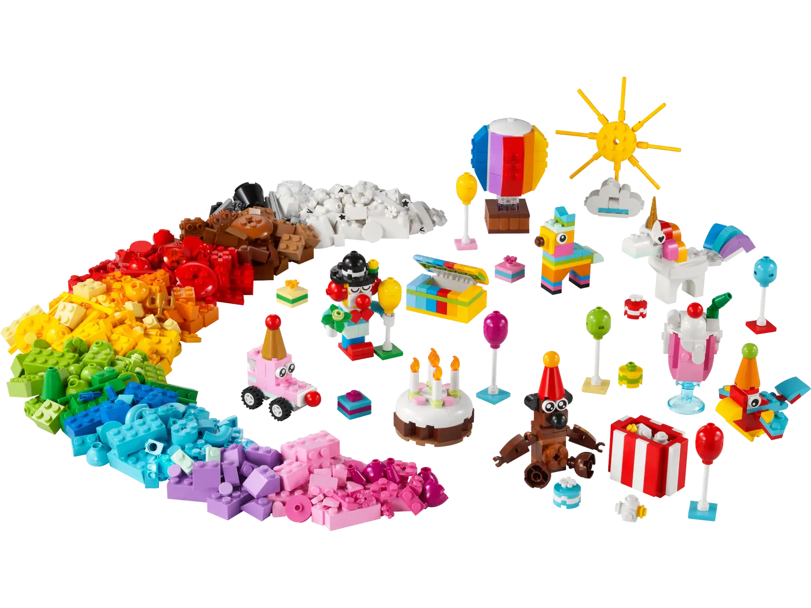 Colorful LEGO® pieces and mini builds from the LEGO® Classic Creative Party Box by Legos - Toyhouse are arranged, featuring a sun, hot air balloon, cake, presents, unicorns, and various small decorations. All elements of this imaginative building toy are displayed against a white background.