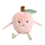 Introducing the MON AMI Peachie Peach by Mon Ami, an adorable stuffed animal in the shape of a peach. It comes complete with a cheerful smiley face, two arms, two legs, a brown stem, and a green leaf.