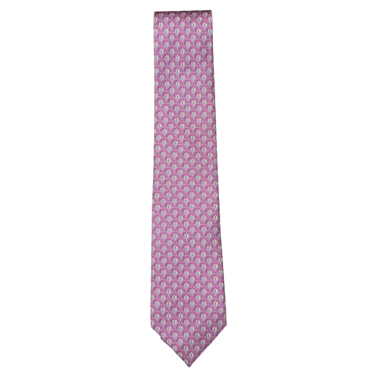 The Peacock Motif Tie by Robert Jensen is hand-stitched in pink silk, showcasing a repeating small white and blue floral pattern, and is displayed against a plain white background.