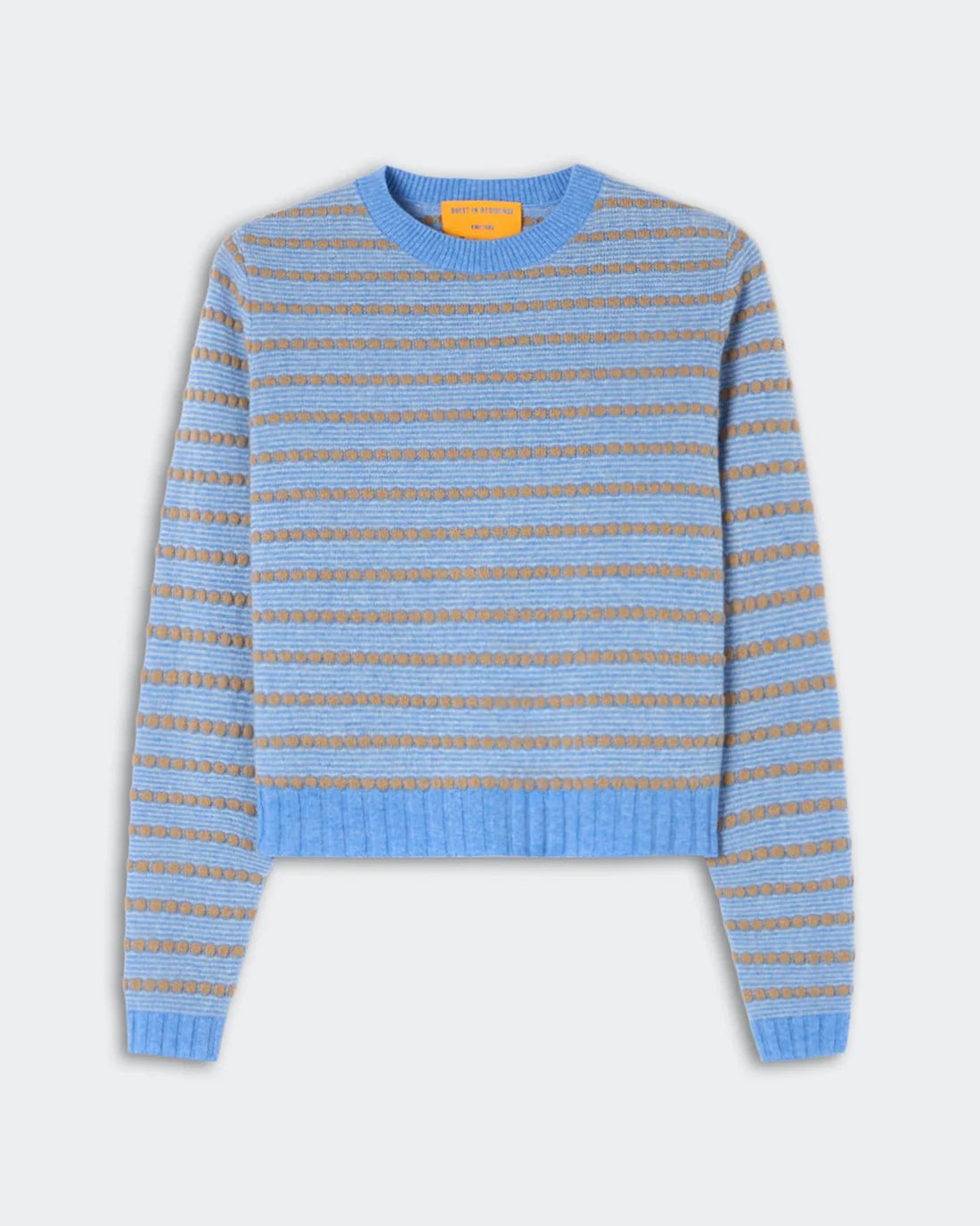 The Pebble Stripe Shrunken Crew by Guest in Residence is a long-sleeve knit sweater featuring blue and beige stripes, with ribbed cuffs, hem, and collar in a flattering cropped fit, displayed against a plain light background.