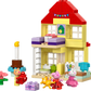 The LEGO® Peppa Pig Birthday House set includes colorful LEGO DUPLO blocks, three animal figures, a cake, flowers, a small horse, and gift boxes arranged in front.