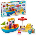 The LEGO® Peppa Pig Boat Trip set by LEGO® includes a boat, sandcastle, beach umbrella, and two Peppa Pig figures. Box shown in background. Ideal preschool learning toy for ages 2+.