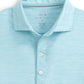 The Johnnie-O Huronn Featherweight Polo in light blue showcases a spread collar and a placket with three white buttons. This medium-sized performance polo from Johnnie-O features a subtle heather pattern, a logo on the inside collar, and offers UPF 50 sun protection.