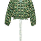 The Perrin Top by Cara Cara is a green, button-up blouse featuring a geometric pattern, long sleeves, and an adjustable drawstring waist. Crafted from breezy cotton voile fabric, it is displayed against a plain white background.