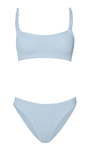 The Hunza G Phoebe Bikini features light blue crinkle fabric, a square neck top with braided straps, and matching high-cut bottoms, shown against a white background.