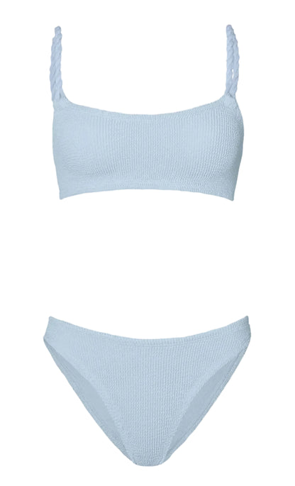The Hunza G Phoebe Bikini features light blue crinkle fabric, a square neck top with braided straps, and matching high-cut bottoms, shown against a white background.