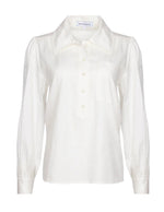 The Hunter Bell Phoenix Shirt by Hunter Bell NYC is a versatile white blouse with long sleeves, a tailored collar, and a button-up front.