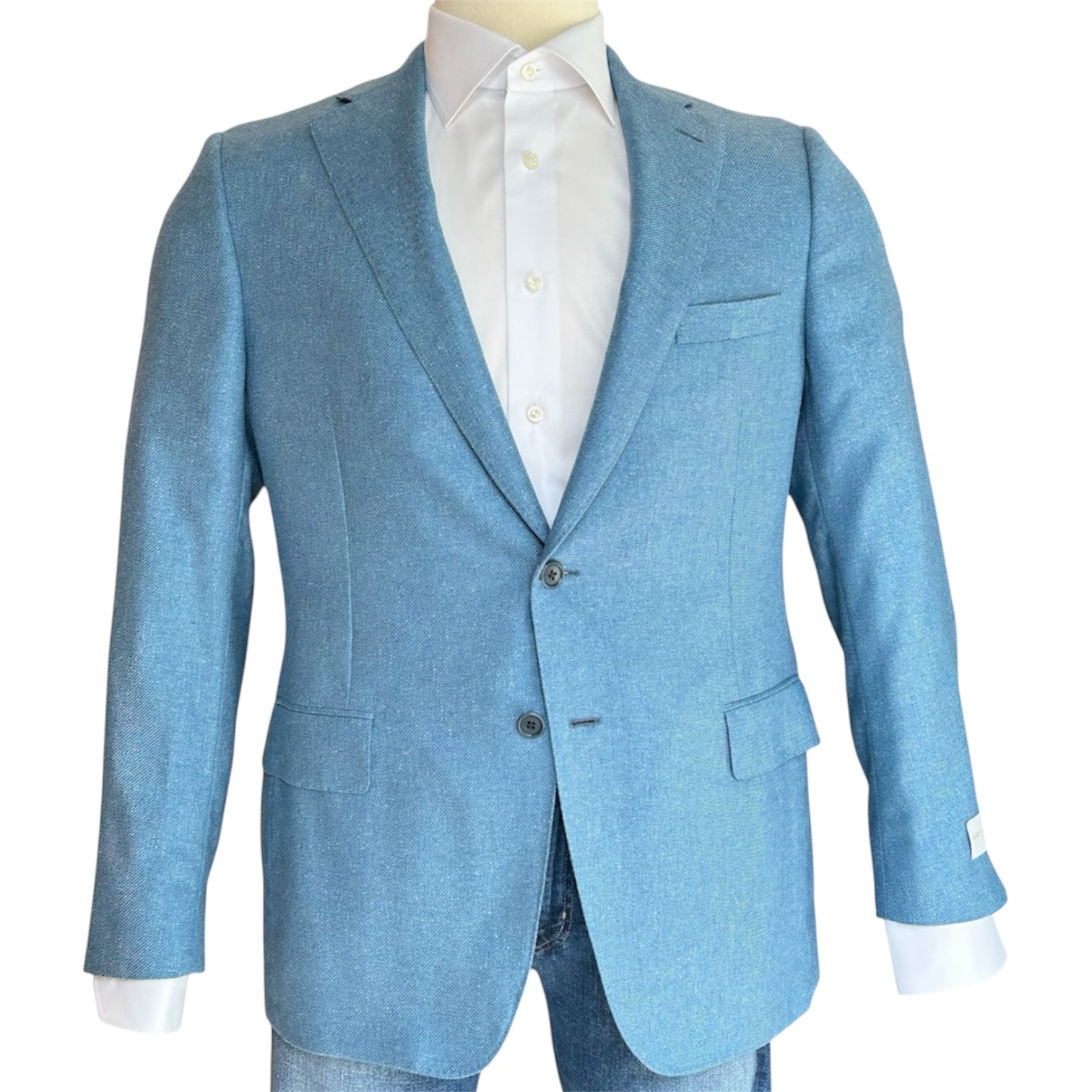 The Samuelsohn Bennet Contemporary Fit Blazer in light blue, featuring notched lapels, two front buttons, and flap pockets, is styled over a white dress shirt and blue jeans on a mannequin.