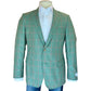 The Bennet Contemporary Fit Blazer by Samuelsohn, a green plaid hand-tailored jacket with notch lapel and two buttons, is shown on a mannequin with a white dress shirt and blue jeans.