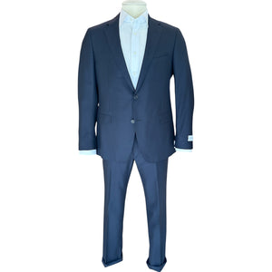 A navy blue Bennet Contemporary Fit Suit by Samuelsohn in Super 130's Honey Way fabric, paired with a white dress shirt and displayed on a headless mannequin against a white backdrop. Crafted in quality cloth by Tallia Di Delfino.