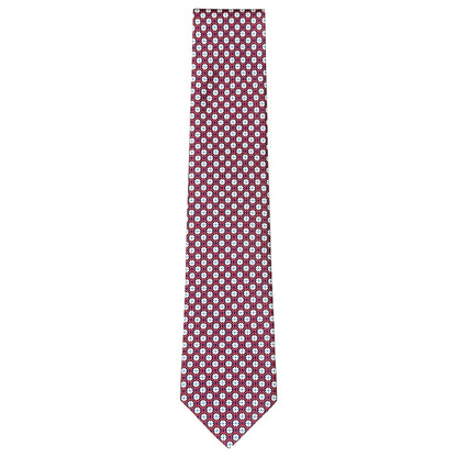The Maltese Cross Tie by Robert Jensen is hand-stitched in Italy from red silk, featuring a repeating pattern of small white and blue circular shapes.