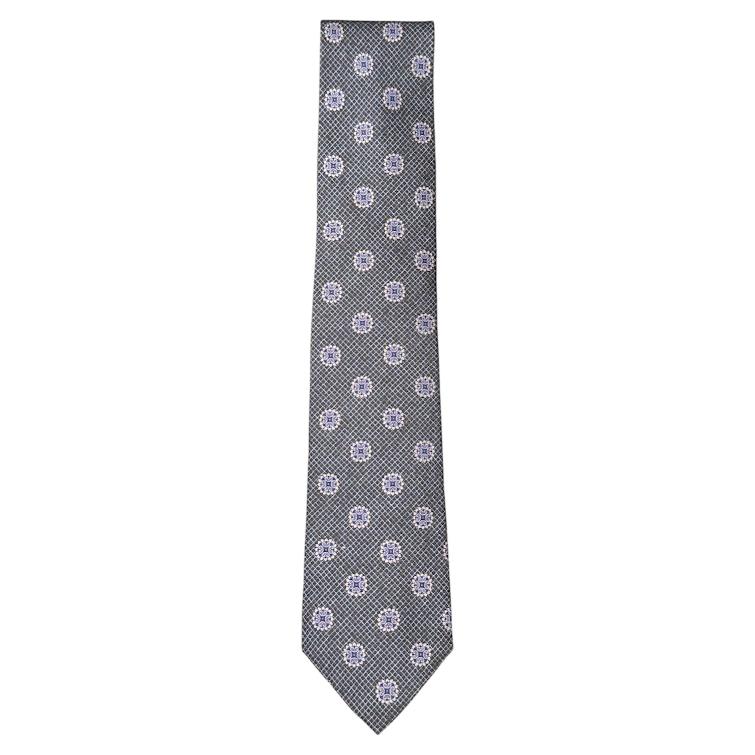 The Starburst Tie by Robert Jensen is a gray silk tie, hand-stitched in Italy, featuring a small checkered pattern with repeating white and blue circular floral motifs.