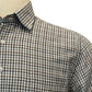 A close-up of the Alan Paine Dunsdale Woven Shirt, featuring a brown and white checkered pattern, button-up front, collar, and front pocket, displayed on a mannequin to highlight its classic design and refined fit.