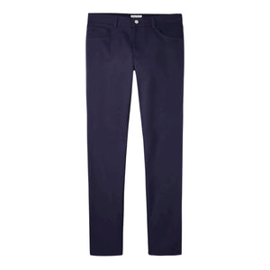 The Peter Millar Performance Five-Pocket Pant is a pair of dark blue slim-fit golf pants made from stretch twill, featuring front and back pockets and a button-zipper closure, shown laid flat on a white background.