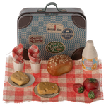 The Maileg Picnic Set by Maileg features a charming collection of a small vintage-style metal suitcase and assorted miniature food items, including bread, tomatoes, drinks, napkins, and plates, all arranged on a red and white checkered cloth.