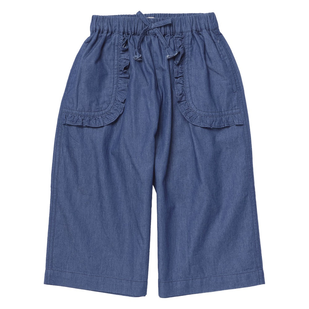 Pink Chicken Girls’ Bailey Ruffle Pant in blue chambray features wide legs, an elastic waistband with a front drawstring, and charming ruffled trim on its spacious front pockets—effortlessly stylish and comfortable girls’ pants laid flat on a white background.
