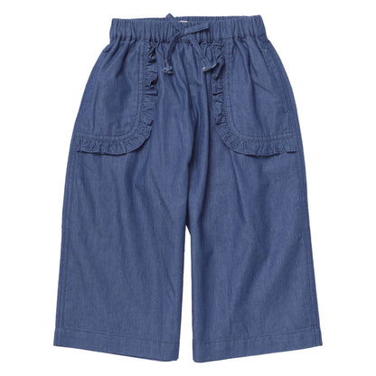 Pink Chicken Girls’ Bailey Ruffle Pant in blue chambray features wide legs, an elastic waistband with a front drawstring, and charming ruffled trim on its spacious front pockets—effortlessly stylish and comfortable girls’ pants laid flat on a white background.