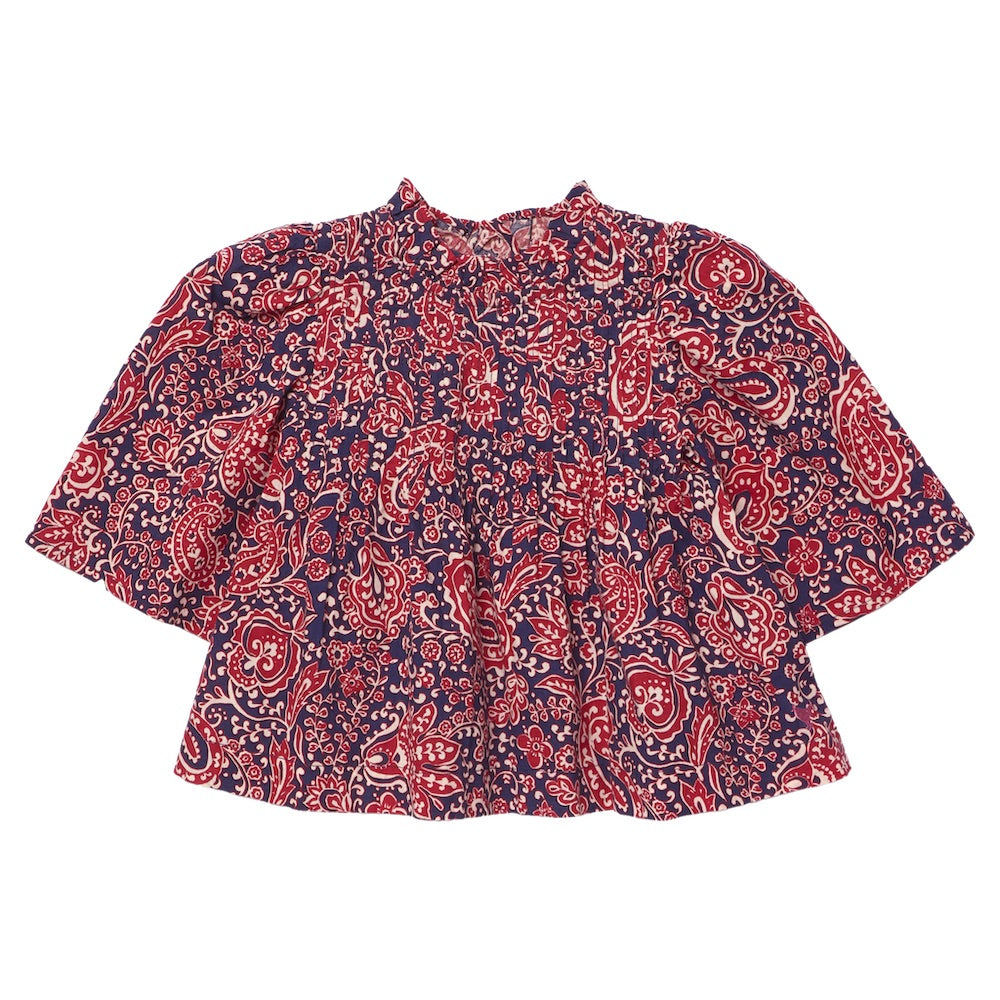 The Girls’ Jaipur Top by Pink Chicken features a red and navy paisley pattern with long bell sleeves, a round neckline, and navy glitter buttons for an elegant touch. Its loose fit offers both comfort and effortless style.